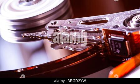 Close-up of a hard disk drive reading data, showcasing the intricate mechanics of data storage Stock Photo