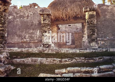 Stone columns supporting a thatched roof at mayan ruins in tulum, mexico Stock Photo