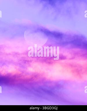 A Full Moon Against A Detailed Colorful Cloudscape Vertical Banner Stock Photo