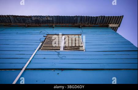 Bayahibe, Dominican Republic 1 January 2025: Wooden planks painted light blue with a rusty corrugated iron roof and a small window Stock Photo