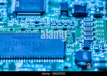 Milan, Italy 1 January 2025: Printed circuit board showcasing intricate electronic components, highlighting the complexity of modern technology Stock Photo