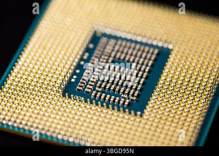 Milan, Italy 1 January 2025: Central processing unit showing gold contacts and circuitry on blue background Stock Photo