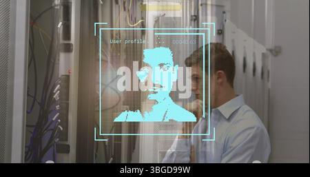 Standing man studying holographic profile in data center, with server racks, cables, copy space Stock Photo