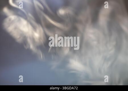 wisps of smoke on a dark background Stock Photo