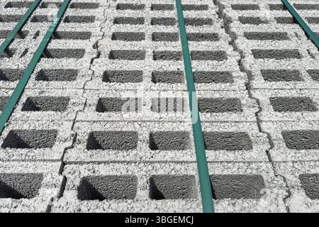 Stacked aerated concrete blocks viewed from above with green straps securing the load. No people. Suitable for construction and industrial backgrounds Stock Photo