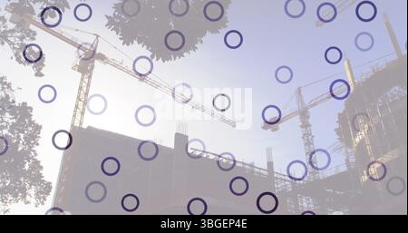 Image of falling circles over construction site Stock Photo