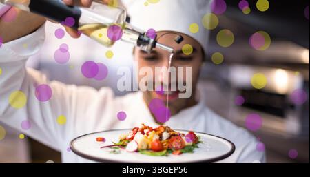 Image of falling yellow and purple dots over cook Stock Photo