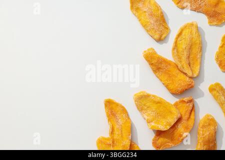 Dried mango chips on a white background Stock Photo