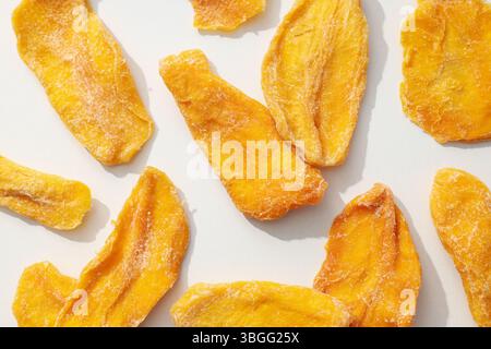 Dried mango chips on a white background Stock Photo