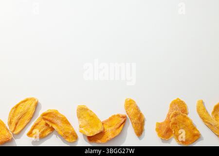 Dried mango chips on a white background Stock Photo