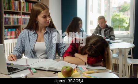 Caucasian girls high school students women gen z teenagers pupils schoolgirls university college education studying problem sleep fall asleep overwork Stock Photo