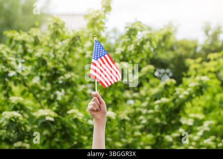 Waving an American flag at the Independence Day Parade on the 4th of July Stock Photo