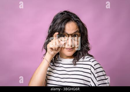 portrait of young adult hispanic woman in her 40s with glasses. concept of eye care and vision care and eyeglasses Stock Photo