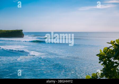 Perfect surfing waves for surfing in Bali. Coastline and ocean waves in Indonesia Stock Photo