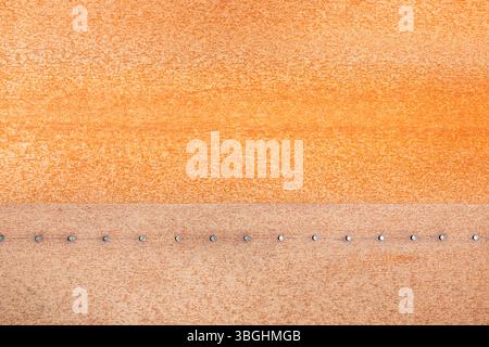 Rusty iron plate with rivets as background Stock Photo