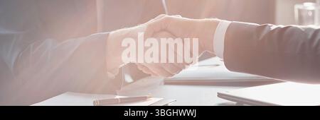 Website header shot of Caucasian middle aged men shaking hands coming to successful business agreement at office desk Stock Photo
