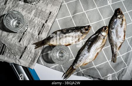 Vodka Glasses on Table with Dried Fish – Traditional Russian Snack Stock Photo