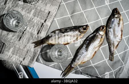 Vodka Glasses on Table with Dried Fish – Traditional Russian Snack Stock Photo