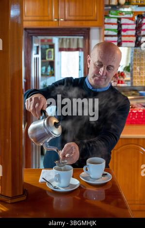 Albania, Balkan Peninsula, Southeast Europe, Republic of Albania (Shqiperia), valley near Gjirokastra, Polican, Taverna Thanasi, real Albanian restaurant at the end of the world, man preparing tea Stock Photo