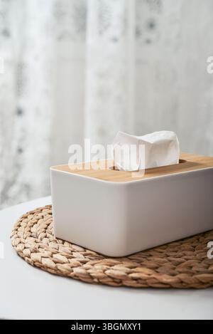 White tissue box with wooden bamboo top on table close up Stock Photo