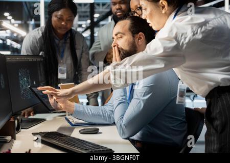 Team of admins working together in server hub, analyzing rigs data. Data center office IT professionals doing brainstorming, examining supercomputers gear, ensuring system integrity and security Stock Photo