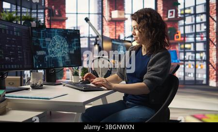 Teleworking developer using computer for artificial intelligence computing through self learning algorithms. Agency IT engineer works with AI deep neural networks on desktop PC. Camera A. Stock Photo