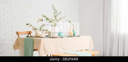 Elegant table setting with blooming tree branches Stock Photo