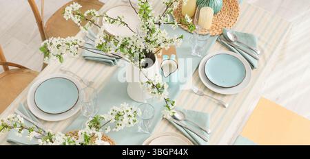 Elegant table setting with blooming tree branches Stock Photo
