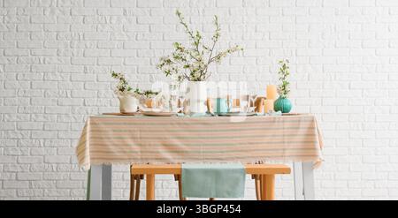 Elegant table setting with blooming tree branches Stock Photo