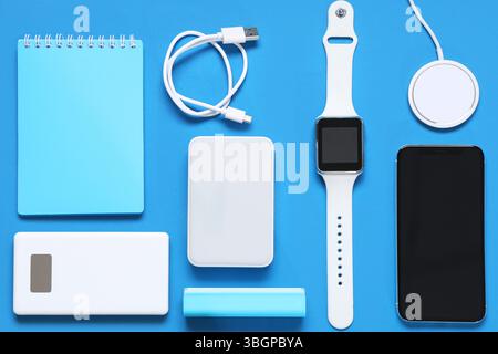 Composition with different modern gadgets and notebook on color background Stock Photo