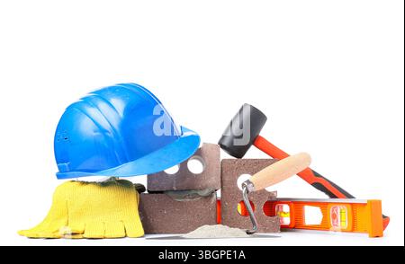 Hardhat, bricks and construction tools with cement on white background Stock Photo