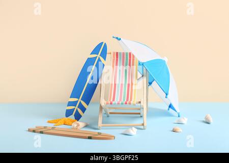 Mini deck chair with surfboards, umbrella and seashells on colorful background Stock Photo