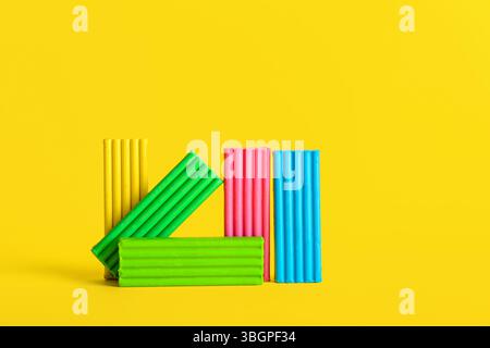 Colorful plasticine on yellow background Stock Photo