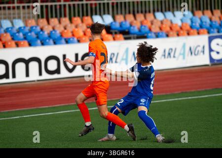 "Action from a Lithuanian II Lyga B Division football match – players in motion during a regional league game." Stock Photo