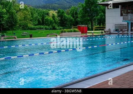 View of the surface of blue water in a public outdoor swimming pool in park Stock Photo