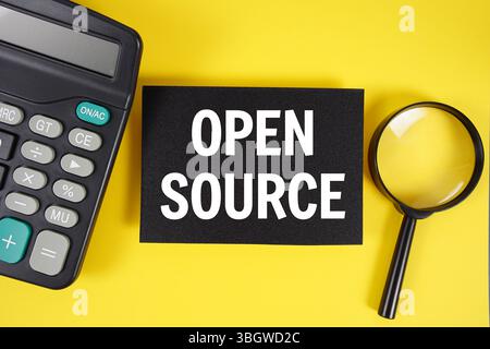 Open Source text with magnifying glass anc calculator on yellow background Stock Photo