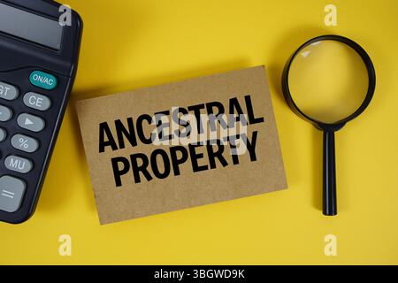 Ancestral Property text with magnifying glass anc calculator on yellow background Stock Photo