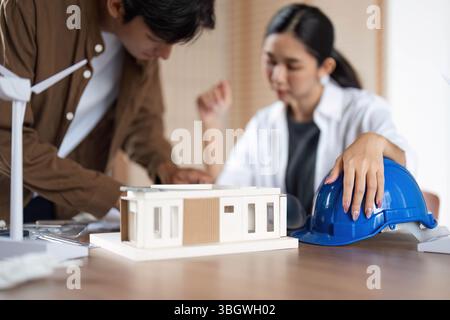 ESG Focused Design. Young professionals strategizing sustainable architecture solutions. Stock Photo