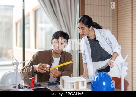 Sustainable Development and ESG. Architects discussing eco-friendly building models. Stock Photo