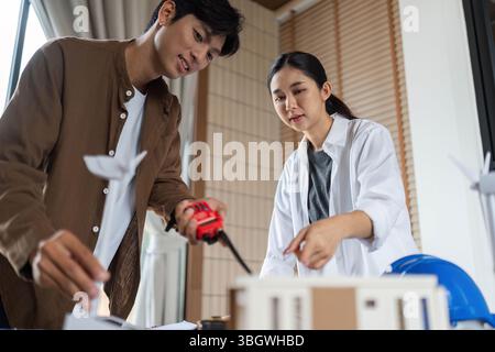 ESG Focused Teamwork. Architects collaborating on a sustainable model project. Stock Photo