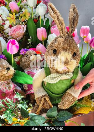 Easter bunny with flowers. Easter bunnies in a basket with flowers Stock Photo