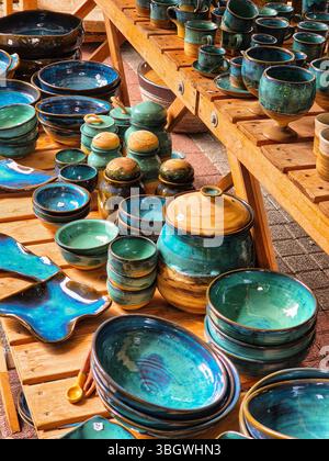 Ceramic and clay emerald colored dishes on the table. handmade Stock Photo