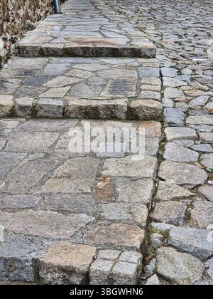 Old cobblestone pavement. stone wall background. old cobblestone pavement, pavement texture. Stock Photo