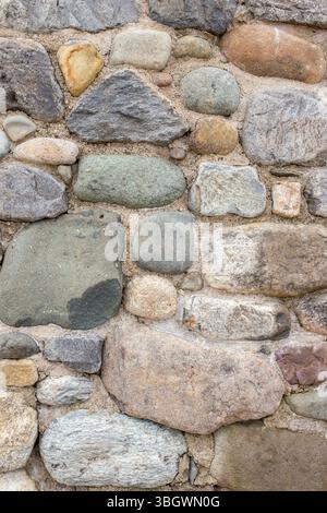 Stone pebble house home wall background backdrop. Natural building materials concept. Stock Photo