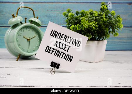 Underlying Asset Definition text written on paper card with alarm clock on wooden background Stock Photo