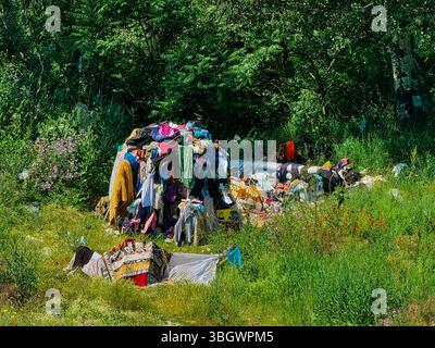 Forest Shelter: Improvised Tent from Forgotten Clothes. Stock Photo