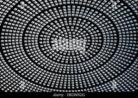 Abstract circular glass ceiling featuring intricate radial patterns and geometric symmetry. Stock Photo