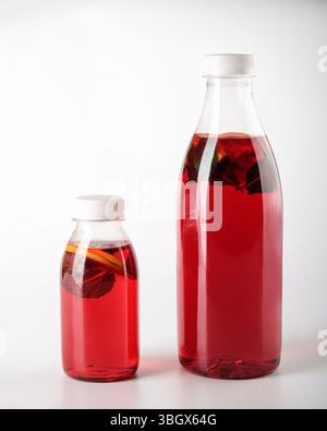 A collection of Vibrant Red Beverage Bottles elegantly arranged on a White Background Stock Photo