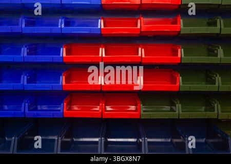 A wall with plastic containers for storing small parts. Stock Photo