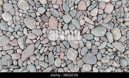 River pebbles with different textures close-up. Stone background Stock Photo